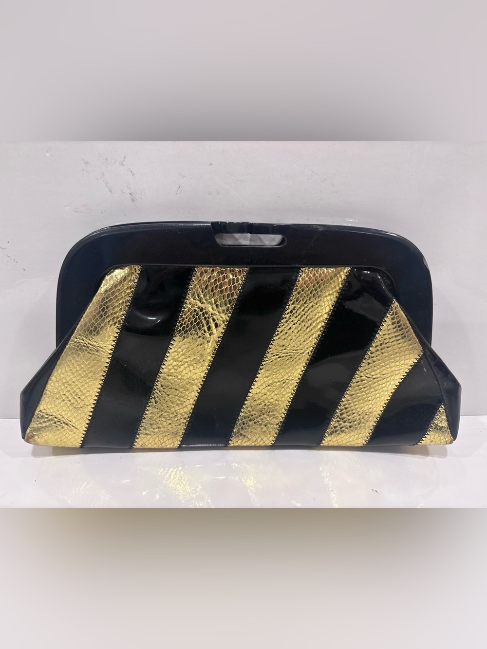 Marciano Black & Gold Striped Patent Clutch